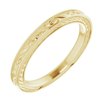 A yellow gold eternity band ring with a detailed floral pattern, shown on a plain white background.