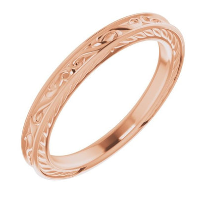 Gold ring with intricate design on a white background