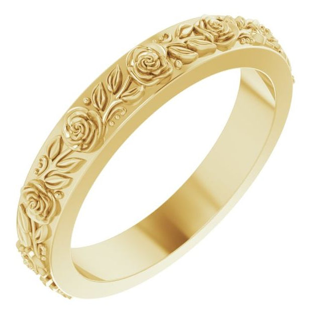 A yellow gold eternity-style ring featuring a continuous raised floral pattern of roses and leaves, shown on a plain white background.
